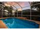 Inviting screened in pool with an integrated spa and a covered patio at 1245 Millbrook Cir, Bradenton, FL 34212