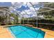 Screened in pool is surrounded by lush landscaping and an outdoor patio area at 1245 Millbrook Cir, Bradenton, FL 34212