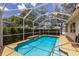 Beautiful in-ground pool with a screened enclosure and sunny patio area at 1245 Millbrook Cir, Bradenton, FL 34212