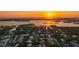 Waterfront neighborhood aerial at sunset features mature trees and luxurious homes with coastal access at 1530 Pine Bay Dr, Sarasota, FL 34231
