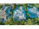 Aerial view of an upscale home with a private pool, screened lanai, and mature landscaping at 1530 Pine Bay Dr, Sarasota, FL 34231
