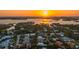 Sunset aerial view of a neighborhood near the sea, showcasing luxury real estate at 1530 Pine Bay Dr, Sarasota, FL 34231