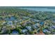 Waterfront neighborhood aerial showcases manicured lawns, mature trees, and homes with access to a peaceful lake at 1530 Pine Bay Dr, Sarasota, FL 34231