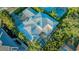 Bird's eye view of an upscale home with a pool, screened lanai, and well-manicured landscaping at 1530 Pine Bay Dr, Sarasota, FL 34231