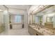 This expansive bathroom offers a soaker tub, granite counters, and neutral decor at 1530 Pine Bay Dr, Sarasota, FL 34231