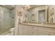 Modern bathroom with dual sinks, granite countertops, white cabinetry, and a glass-enclosed shower at 1530 Pine Bay Dr, Sarasota, FL 34231