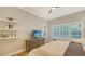 Bright bedroom with a dresser, floating shelves, a television, and access to an outdoor space at 1530 Pine Bay Dr, Sarasota, FL 34231