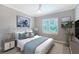 Stylized bedroom features an octopus art piece, a ceiling fan, and a window with plantation shutters at 1530 Pine Bay Dr, Sarasota, FL 34231