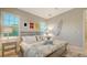 Bright bedroom features nautical decor, plantation shutters, and a large window for ample natural light at 1530 Pine Bay Dr, Sarasota, FL 34231