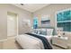 This bedroom is decorated with tropical artwork and plenty of natural light at 1530 Pine Bay Dr, Sarasota, FL 34231