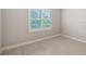 Sunlit bedroom with a large window with plantation shutters and neutral paint at 1530 Pine Bay Dr, Sarasota, FL 34231