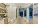 An open dining room with a wine bar and sliding doors leading to the pool and outdoor living space at 1530 Pine Bay Dr, Sarasota, FL 34231