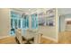 Elegant dining room features a large table, stylish chandelier, and access to the outdoor patio at 1530 Pine Bay Dr, Sarasota, FL 34231