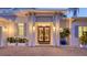 Grand entrance with elegant double doors, beautiful plants, and a brick paver driveway at 1530 Pine Bay Dr, Sarasota, FL 34231
