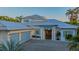 Elegant single-story home with a three-car garage, manicured lawn, and professional landscaping at 1530 Pine Bay Dr, Sarasota, FL 34231