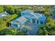 Stunning home featuring a metal roof, hurricane shutters, and a lush landscape for privacy at 1530 Pine Bay Dr, Sarasota, FL 34231