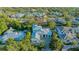 Beautiful home with lush landscaping, a metal roof, and a paved driveway is showcased in this shot at 1530 Pine Bay Dr, Sarasota, FL 34231