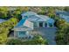 Stunning home with a metal roof, impact windows, meticulous landscaping, and a brick paved drive at 1530 Pine Bay Dr, Sarasota, FL 34231