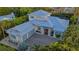 Exterior view of the home featuring a long brick paved drive leading up to a three car garage at 1530 Pine Bay Dr, Sarasota, FL 34231