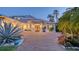 Stunning home with a brick driveway, lush tropical landscaping, and a beautiful entryway with wood double doors at 1530 Pine Bay Dr, Sarasota, FL 34231