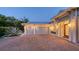 Spacious three-car garage with a brick driveway and attractive landscaping, perfect for car enthusiasts at 1530 Pine Bay Dr, Sarasota, FL 34231