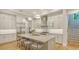 Spacious kitchen with a large island, stainless steel appliances, and access to the staircase at 1530 Pine Bay Dr, Sarasota, FL 34231