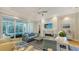 Spacious living room with modern furniture, a fireplace, and sliding doors to an outdoor pool at 1530 Pine Bay Dr, Sarasota, FL 34231