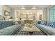 Cozy living room featuring stylish sofas, elegant decor, and an open layout to the kitchen at 1530 Pine Bay Dr, Sarasota, FL 34231