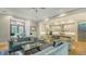 Open-concept living room connects to a modern kitchen with an eat-in bar at 1530 Pine Bay Dr, Sarasota, FL 34231