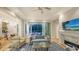 Living room with fireplace and hardwood floors leading to the kitchen and pool area at 1530 Pine Bay Dr, Sarasota, FL 34231