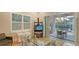 Comfortable office space featuring a glass desk, a TV on a stand, and access to the outdoor living space at 1530 Pine Bay Dr, Sarasota, FL 34231