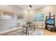 Bright office featuring modern furnishings, a glass desk, neutral walls, and a large window with plantation shutters at 1530 Pine Bay Dr, Sarasota, FL 34231