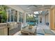 Outdoor kitchen area complete with stainless steel grill, dining table and chairs, and a view of the pool at 1530 Pine Bay Dr, Sarasota, FL 34231