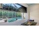 Screened-in patio with a pool, spa, and a modern gas fireplace at 1530 Pine Bay Dr, Sarasota, FL 34231