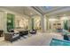 Covered patio with a dining area, lounge area, and views of the open-concept interior at 1530 Pine Bay Dr, Sarasota, FL 34231