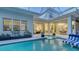 Beautiful pool and spa area with lounge chairs, open to the home's interior via sliding glass doors at 1530 Pine Bay Dr, Sarasota, FL 34231