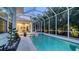 Inviting screened-in pool with a spa, set amidst lush tropical landscaping at 1530 Pine Bay Dr, Sarasota, FL 34231