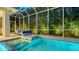 Relaxing screened-in pool with lounge chairs surrounded by lush landscaping at 1530 Pine Bay Dr, Sarasota, FL 34231