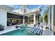 Inviting screened-in lanai features a pool with a spa, lounge chairs, and outdoor dining space at 1530 Pine Bay Dr, Sarasota, FL 34231