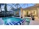 Inviting pool area featuring a heated spa, lounge chairs, and screen enclosure at 1530 Pine Bay Dr, Sarasota, FL 34231