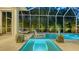 Outdoor heated spa flowing to a swimming pool with ample privacy and lounge chairs at 1530 Pine Bay Dr, Sarasota, FL 34231