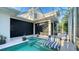 Inviting screened-in lanai features a pool with a spa and lounge chairs at 1530 Pine Bay Dr, Sarasota, FL 34231