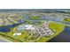 High aerial view showcasing a community's amenities, lake, residential area, and surrounding landscape at 15336 Serene Shores Loop, Bradenton, FL 34211