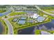 Aerial view showcasing community amenities including a clubhouse, pool, tennis courts, and lush landscaping at 15336 Serene Shores Loop, Bradenton, FL 34211