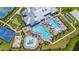Aerial view showcasing community amenities including a clubhouse, pool, tennis courts, and lush landscaping at 15336 Serene Shores Loop, Bradenton, FL 34211