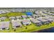An aerial view of a neighborhood with a scenic pond, lush green landscaping, and well-maintained homes at 15336 Serene Shores Loop, Bradenton, FL 34211