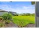 Expansive backyard featuring lush green grass, landscaping, and scenic water views in a well-maintained community at 15336 Serene Shores Loop, Bradenton, FL 34211