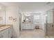 Bathroom featuring double vanities, large mirror, glass shower, and tile flooring at 15336 Serene Shores Loop, Bradenton, FL 34211