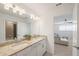 Bathroom with granite countertops, double sinks, and modern lighting at 15336 Serene Shores Loop, Bradenton, FL 34211