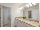 Bathroom with double sinks, granite counters, decorative lights, and a walk-in shower at 15336 Serene Shores Loop, Bradenton, FL 34211